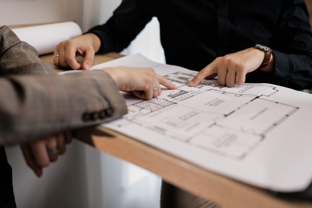 Two people reviewing blueprints